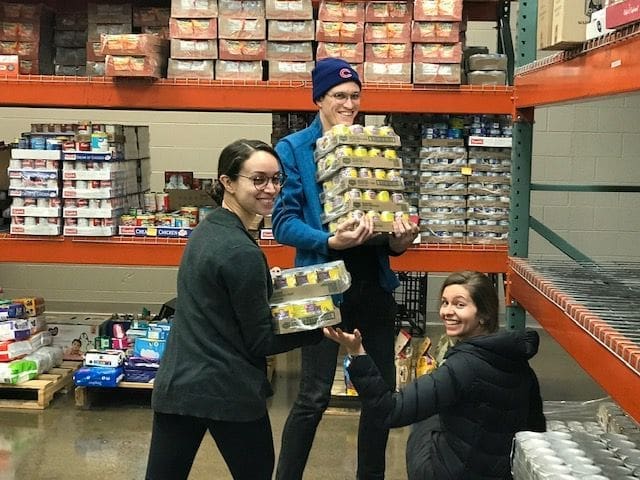 local employees stock a food pantry